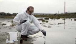 Scientist Measuring Contaminated Soil